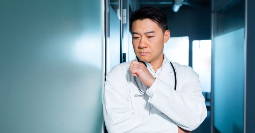 a doctor outside his clinic looking problematic