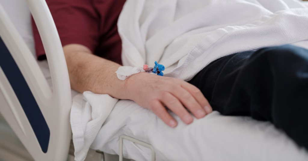 a close up photo of an IV in a patient on a hospital bed