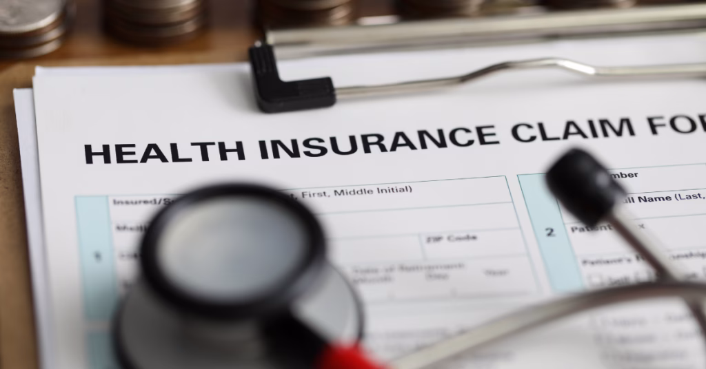 a close up photo of an empty health insurance form in a clipboard with a stethoscope on top