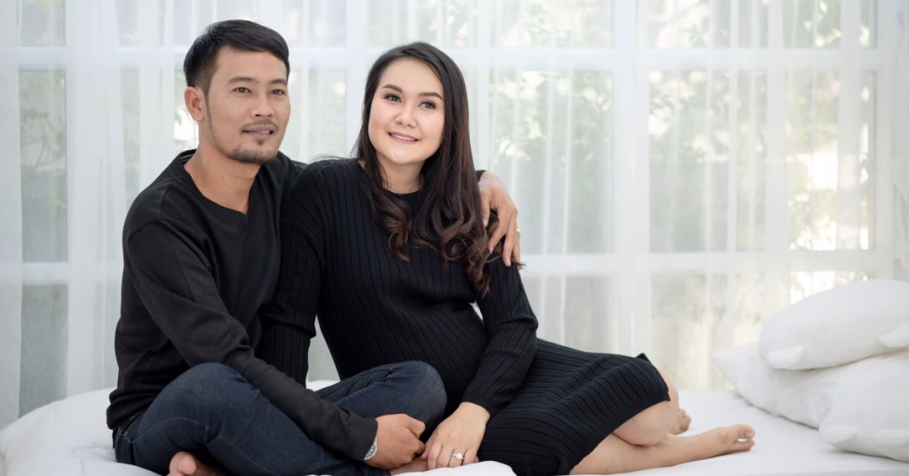 a singaporean couple taking a photo in their house